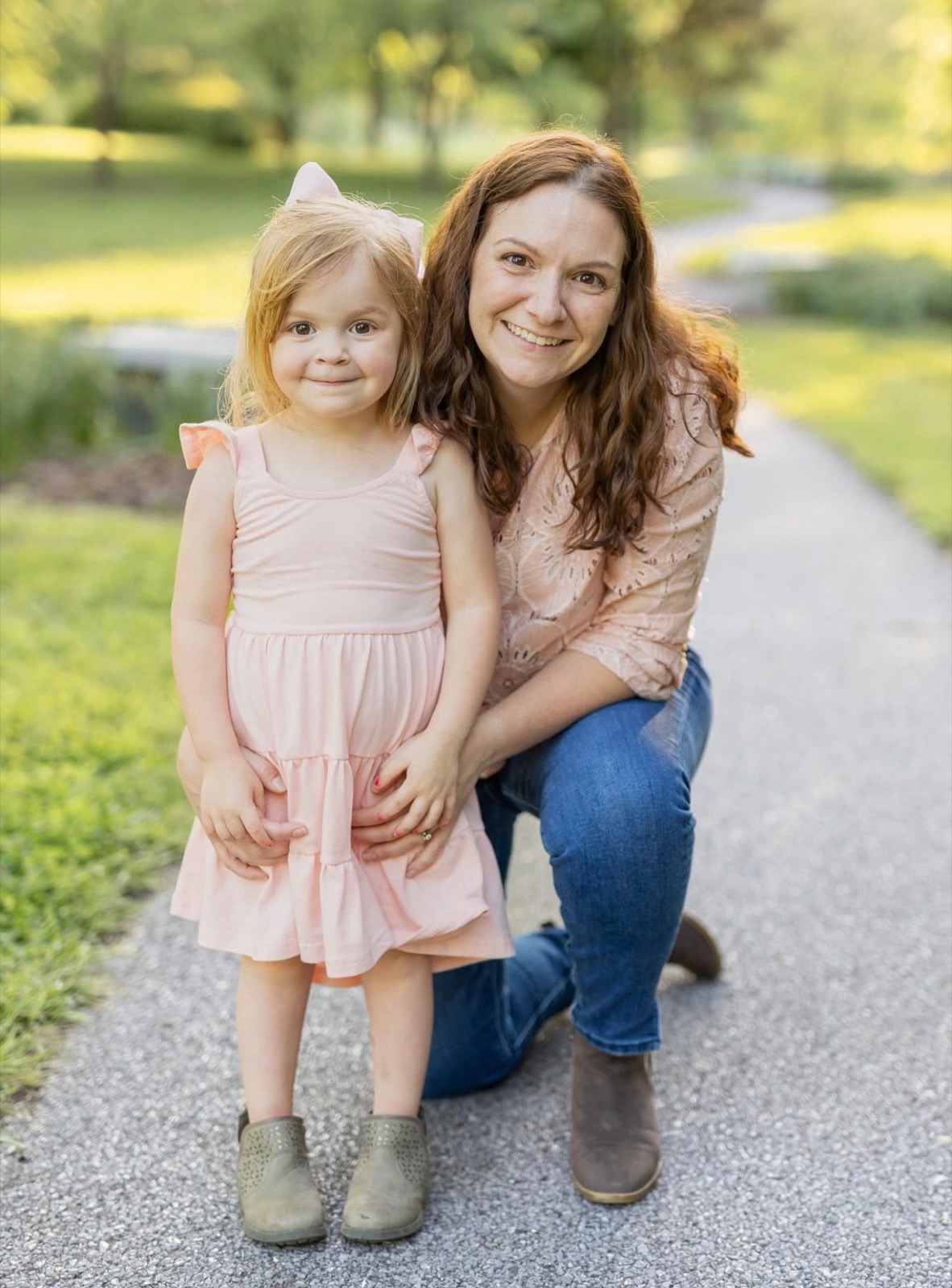 Heidi smiling outdoors with her daughter